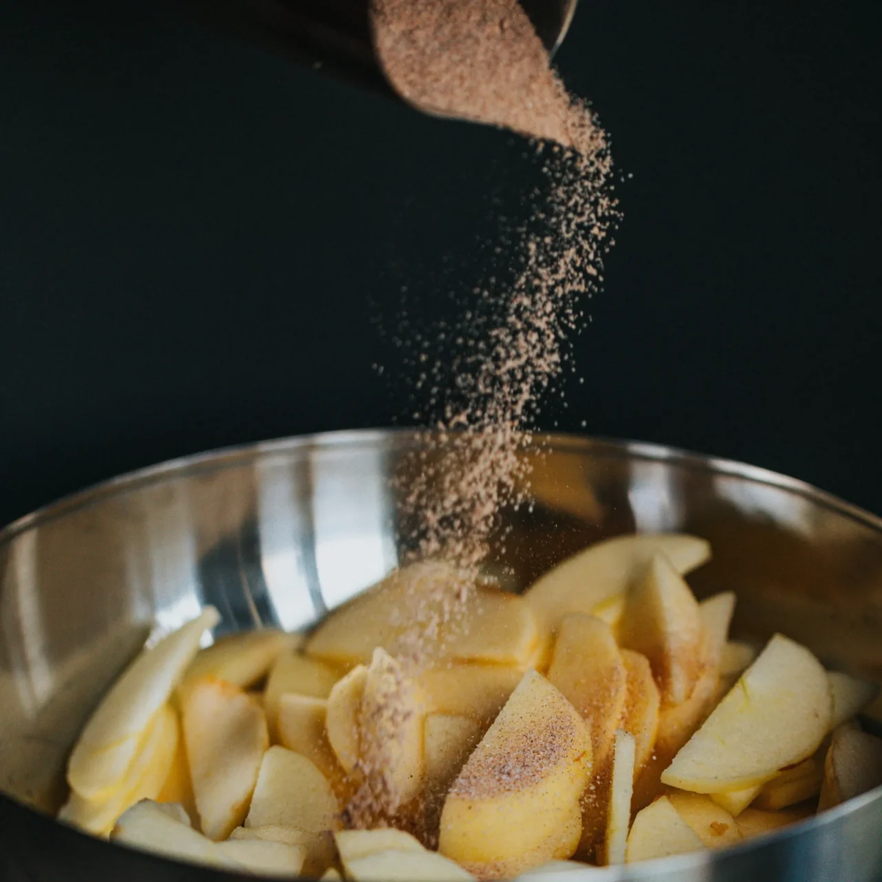 Buttery Cinnamon Roll Seasoning being sprinkled on apples