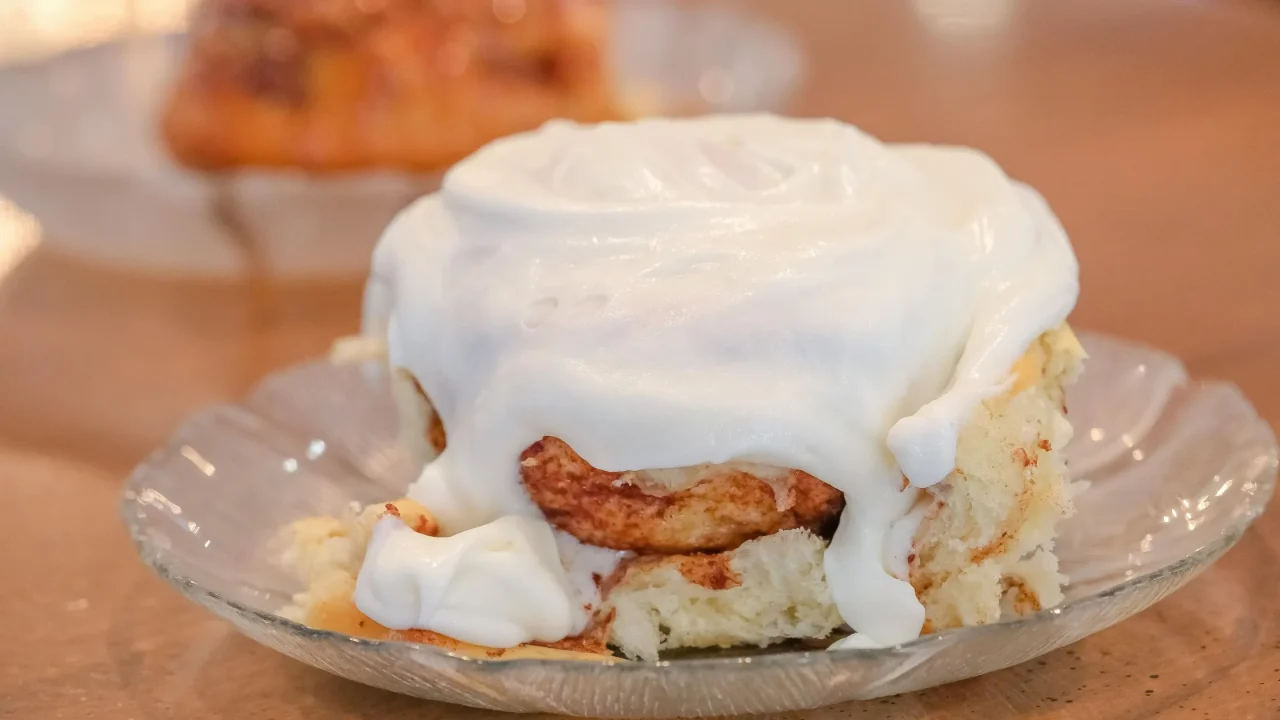 cinnamon roll on a plate covered with frosting at wheatfields bakery in omaha